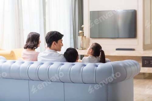 Preview: Happy family watching TV in the living room