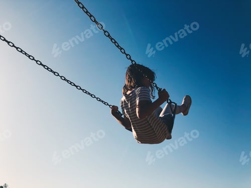Preview: Girl on a swing with blue sky