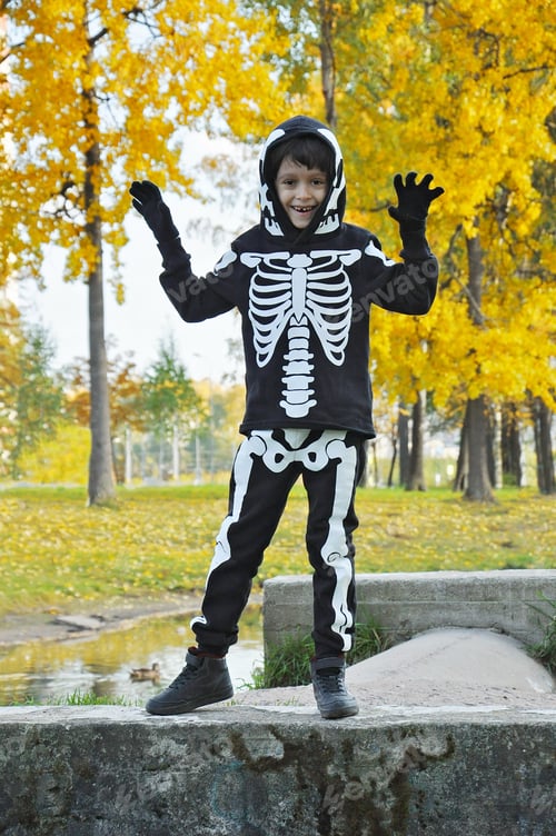 Preview: cheerful preschooler boy in a skeleton costume is going to go to Halloween.
