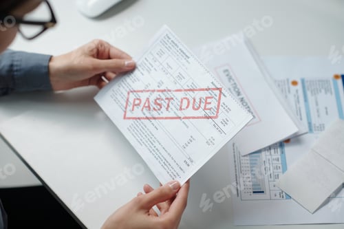 Preview: Female Hand Holding Late Bills Sorting Financial Documents