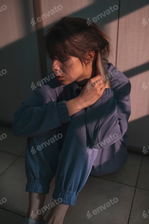 Preview: Upset woman with mental health issues sitting in the dark