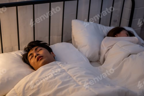 Preview: Asian woman feel frustrated from husband snoring while sleep at night.