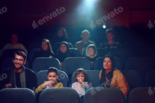 Preview: A modern family enjoys quality time together at the cinema, indulging in popcorn while watching a