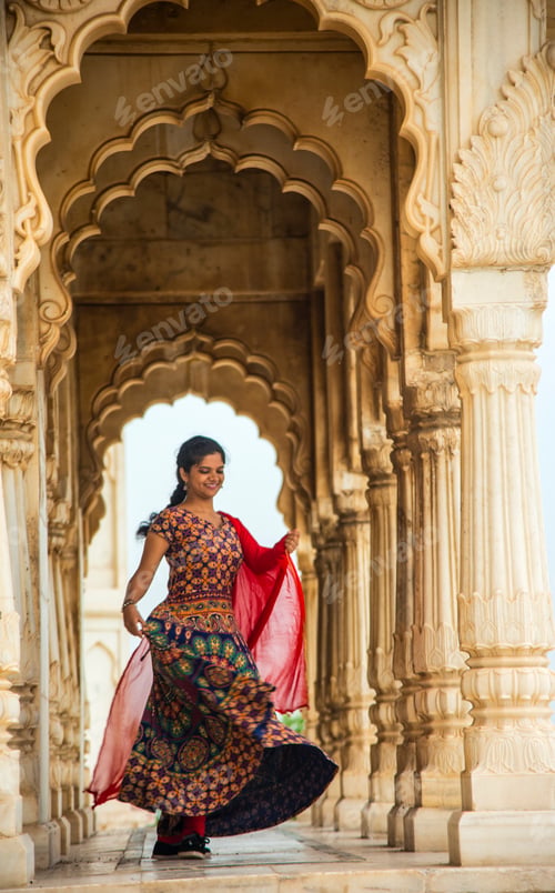 Preview: Young female tourist dancing between arches and Pillars.