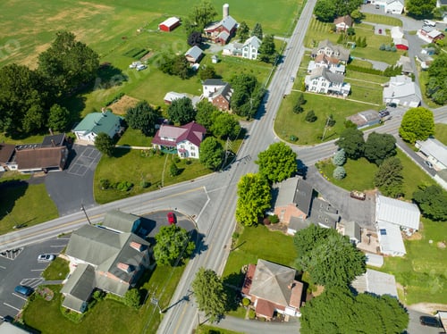 Preview: Aerial view of a countryside area with fields and houses