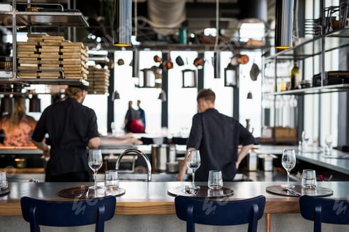 Preview: Rear view of chefs cooking food in kitchen at Skybar restaurant