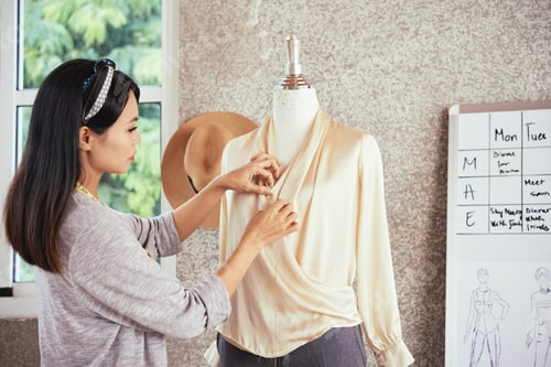 Preview: Asian woman making blouse in studio