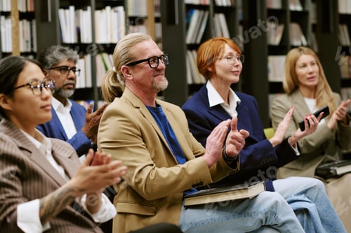 Preview: Diverse Group of People Applauding during Book Presentation