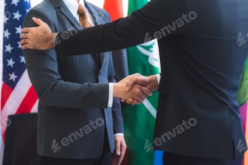Preview: Business people shake hands, international flag background