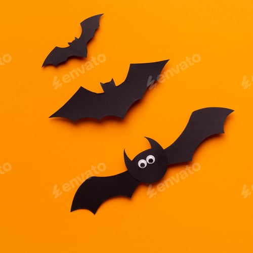 Preview: Close up of funny Halloween bats flying up on orange