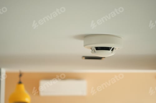 Preview: White smoke detector on ceiling at home