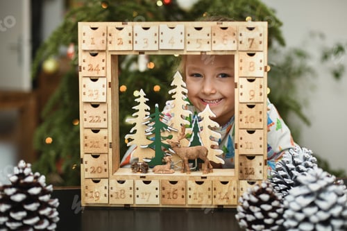 Preview: A girl opens wooden advent calendar with presents