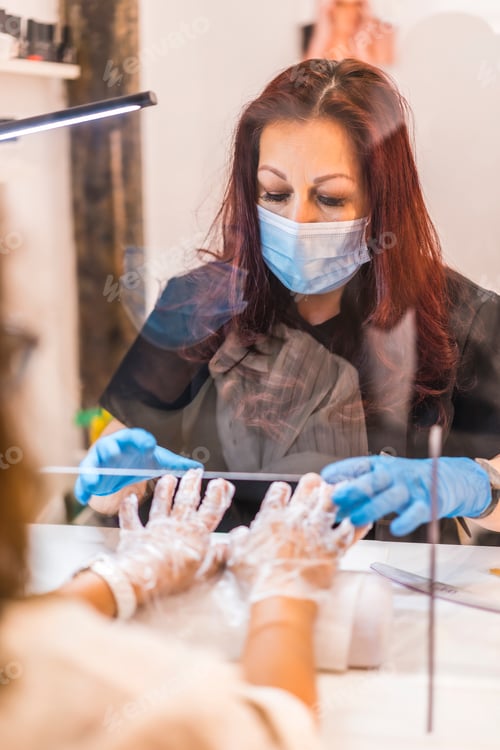 Preview: Nail Technician with Client Wearing Protective Face Mask