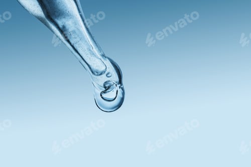 Preview: Macro cosmetic serum drop from glass pipette on blue background, skincare hydration concept