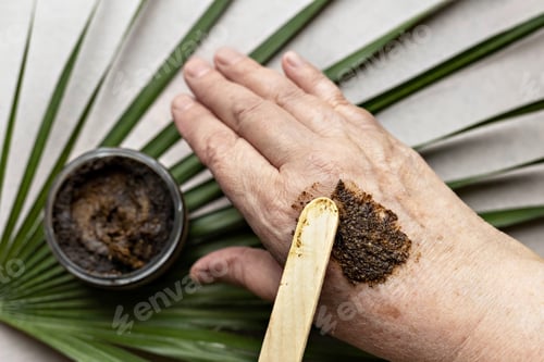 Preview: In a woman's hand is a jar with a Body Scrub made from natural ingredients. Handmade cosmetics.