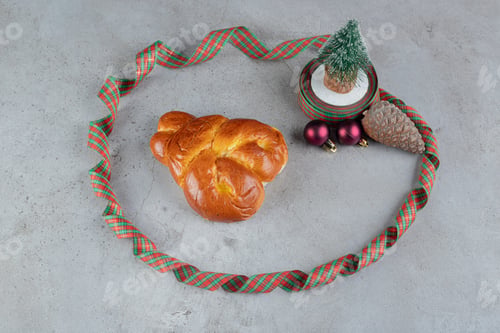 Preview: Christmas candy colored ribbon around a sweet bun and christmas decorations on marble background