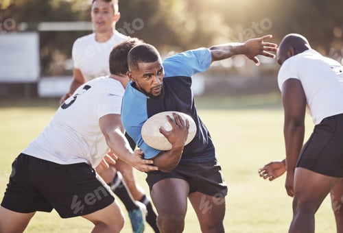 Preview: African american rugby player running away from an opponent while attempting to score a try during