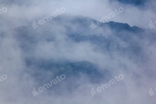 Preview: Fog landscape covering high mountains