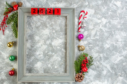 Preview: Top view of fir branches conifer cones decoration accessories numbers on wooden frame and gift