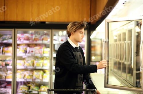 Preview: Man Shopping In Supermarket, Reading Product Information