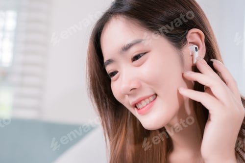 Preview: Asian woman use smartphone and wearing earbuds listening music entertainment