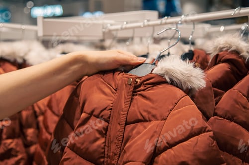Preview: Children's jackets on hangers in a clothing store.