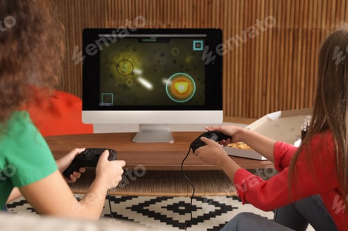 Preview: Young women playing video games at home