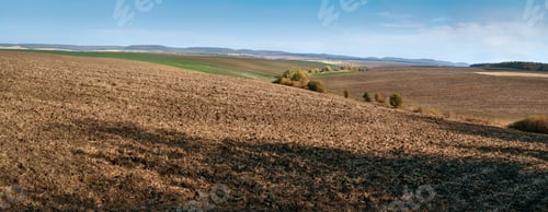 Preview: plowed agricultural land spread out among the hills