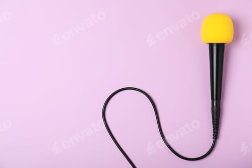 Preview: Modern microphone on color background, top view with space for text