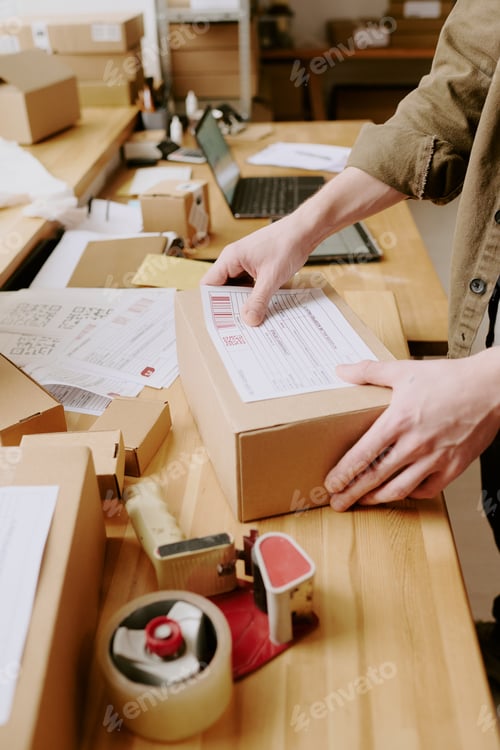 Preview: Packing Parcels at Rustic Wooden Table in Business Setting