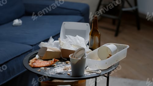 Preview: Close up of messy table, leftover food, dirty dishes in empty living room