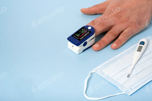 Preview: Human male hands pulse oximeter used to measure pulse rate and oxygen levels