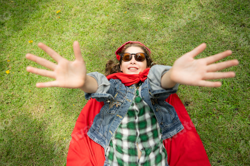 Preview: On a beautiful day in the park, a young girl enjoys her vacation. Playful with a red superhero