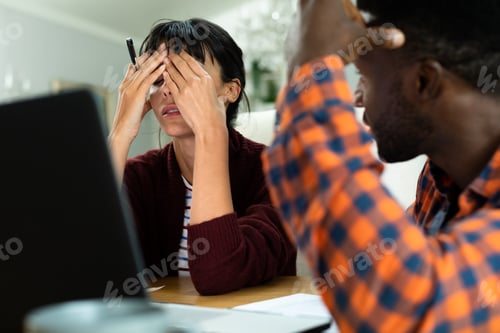 Preview: Tensed multiracial young couple planning household budget at home