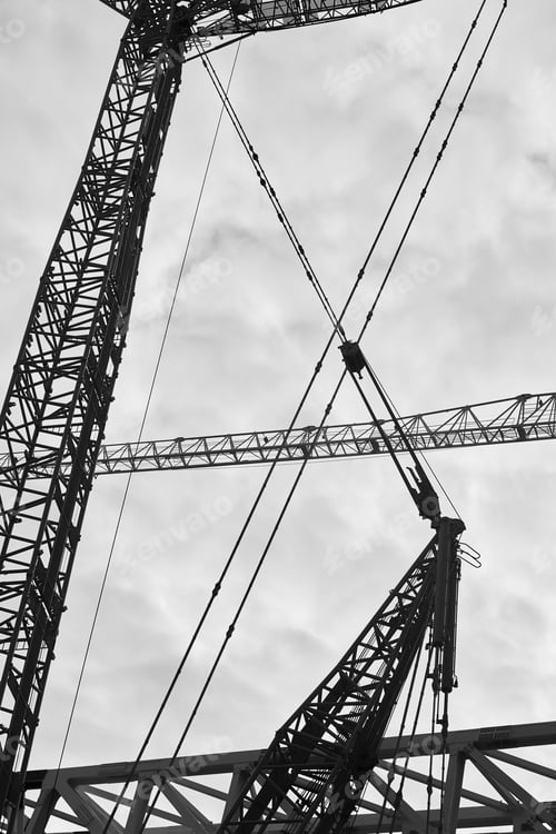 Preview: Several huge cranes in black and white. Construction industry