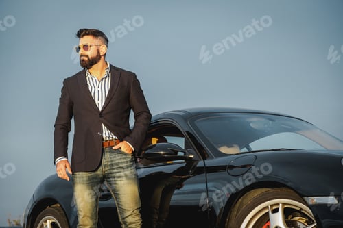 Preview: Handsome elegant male next to his sports car