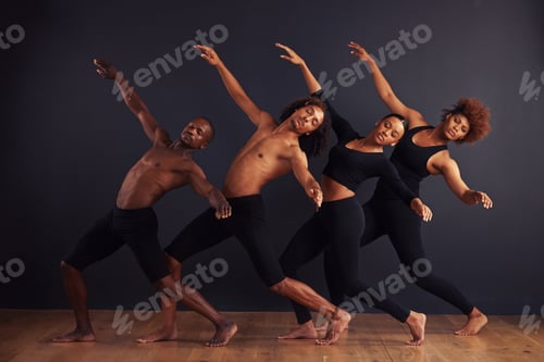 Preview: A group of dancers performing a dramatic pose in front of a dark background