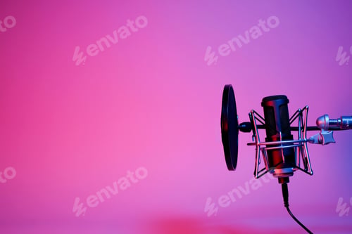 Preview: black microphone on pink and purple neon background with copy space.