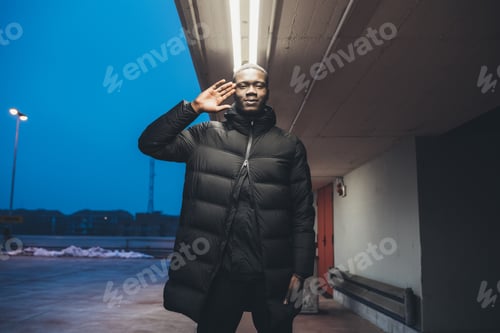 Preview: young black man standing outdoor gesture with hand looking the camera