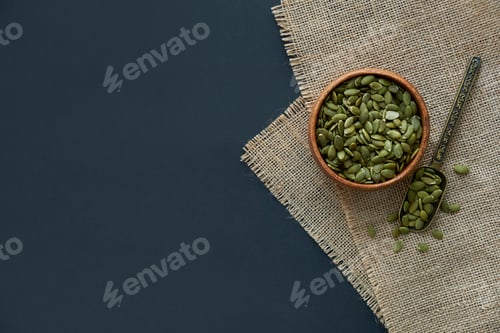 Preview: pumpkin seeds in a wooden bowl and vintage scoop.