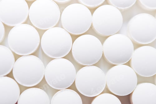 Preview: Scattered white pills isolated on white background.