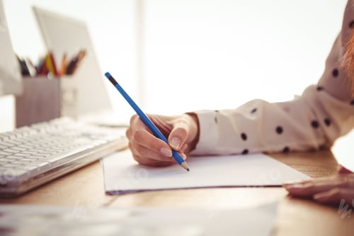Preview: Cropped image of woman drawing in her office