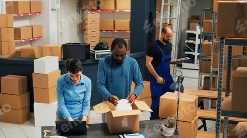 Preview: Employees putting products in boxes and dong highfive