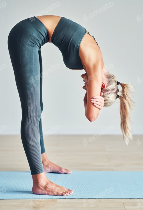 Preview: Adult woman practising yoga at home