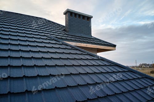 Preview: Closeup of house roof top covered with metallic shingles.Tiled covering of building