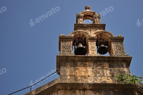 Preview: Steeple of medieval stone church against sky