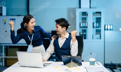 Preview: Asian business colleagues celebrating success at work, expressing happiness and motivation