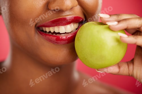 Preview: Woman, mouth and apple for natural nutrition, diet or health and wellness against a red studio back