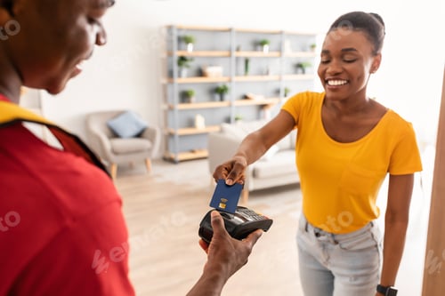 Preview: African Female Paying With Credit Card Standing With Courier Indoor