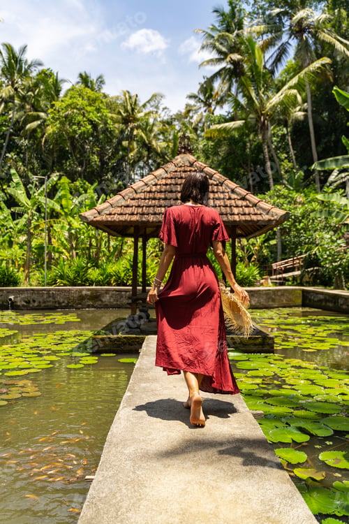 Preview: Young slim woman walking alone in the garden